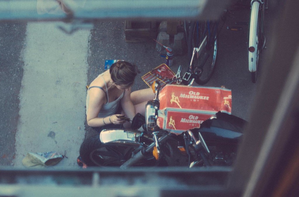 girl fixing her motorcycle